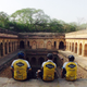 Three members of Kushal Arora’s biking group sitting at a monument.